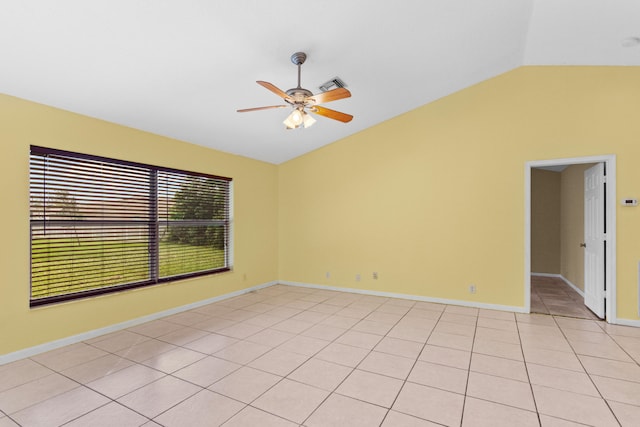 tiled empty room with vaulted ceiling and ceiling fan