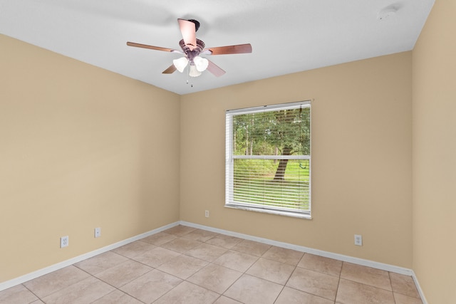 spare room with light tile patterned flooring and ceiling fan