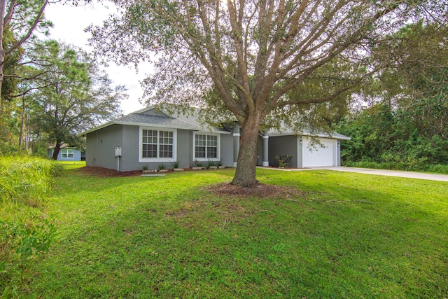 ranch-style house featuring a garage and a front yard