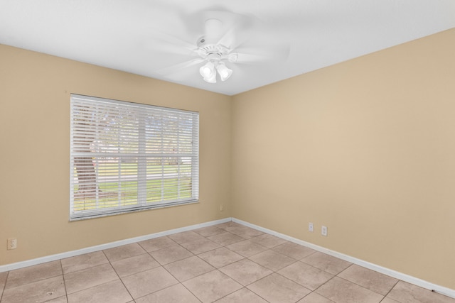 unfurnished room featuring light tile patterned floors and ceiling fan