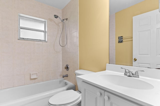 full bathroom with vanity, tiled shower / bath combo, and toilet