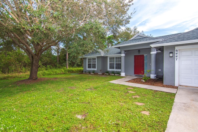 view of front facade with a garage and a front yard