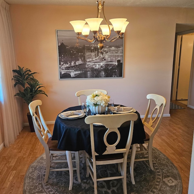 dining room with a chandelier and hardwood / wood-style floors