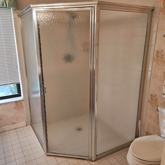 bathroom with walk in shower, toilet, and tile patterned floors