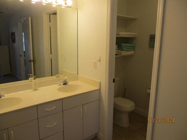 bathroom with tile patterned floors, vanity, and toilet