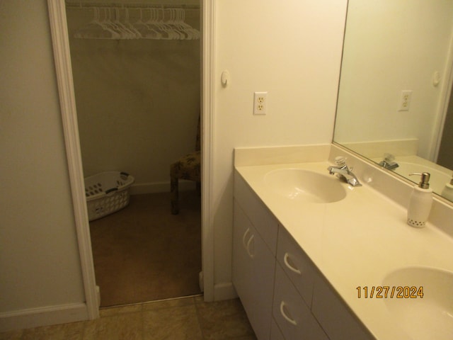 bathroom with tile patterned floors and vanity