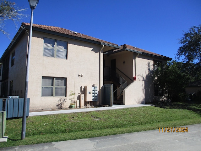 view of side of property with central air condition unit