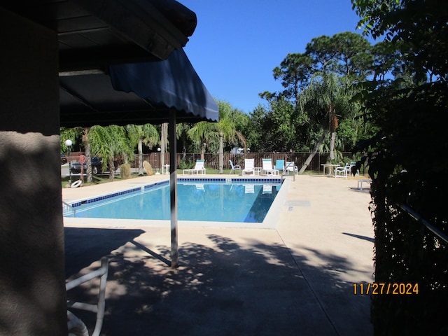 view of swimming pool with a patio area