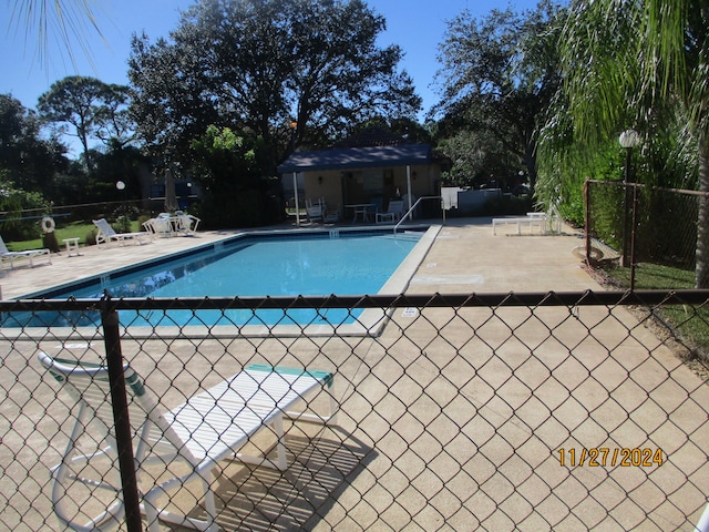 view of swimming pool featuring a patio area