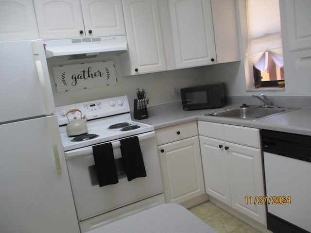 kitchen with sink, white cabinets, white appliances, and light tile patterned floors