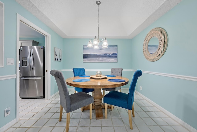 tiled dining area with a textured ceiling