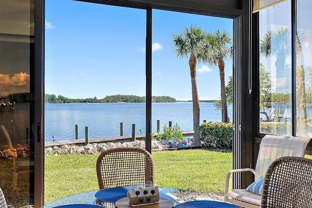 sunroom / solarium featuring a water view