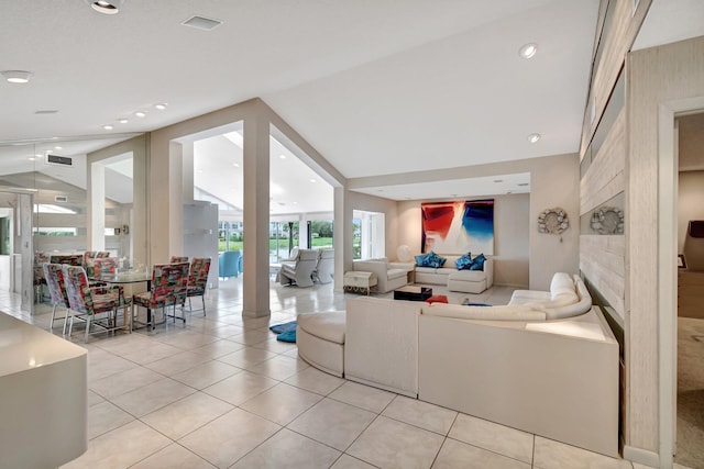 living room with light tile patterned floors and lofted ceiling