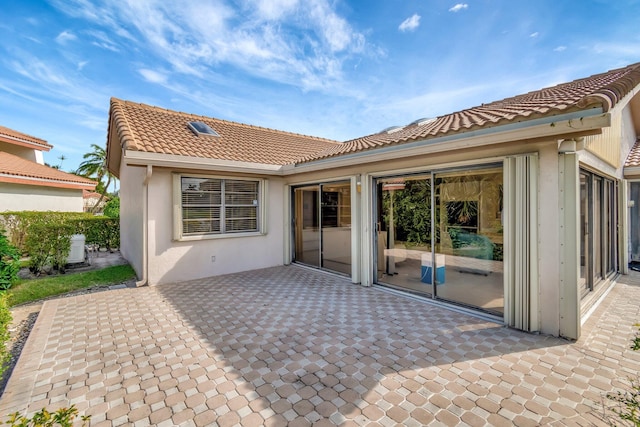 rear view of property featuring a patio area