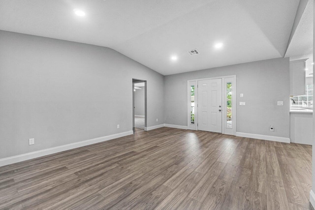 entryway featuring hardwood / wood-style flooring and lofted ceiling