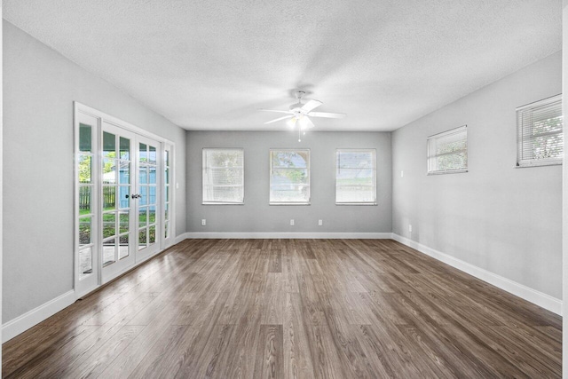 spare room with french doors, a textured ceiling, dark hardwood / wood-style floors, and ceiling fan