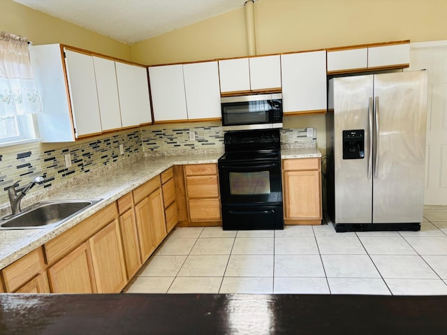 kitchen featuring decorative backsplash, stainless steel appliances, sink, light tile patterned floors, and white cabinetry