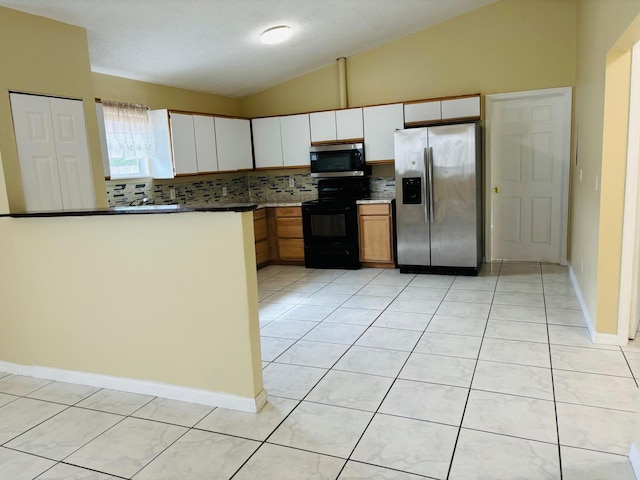 kitchen featuring white cabinetry, backsplash, vaulted ceiling, light tile patterned floors, and appliances with stainless steel finishes