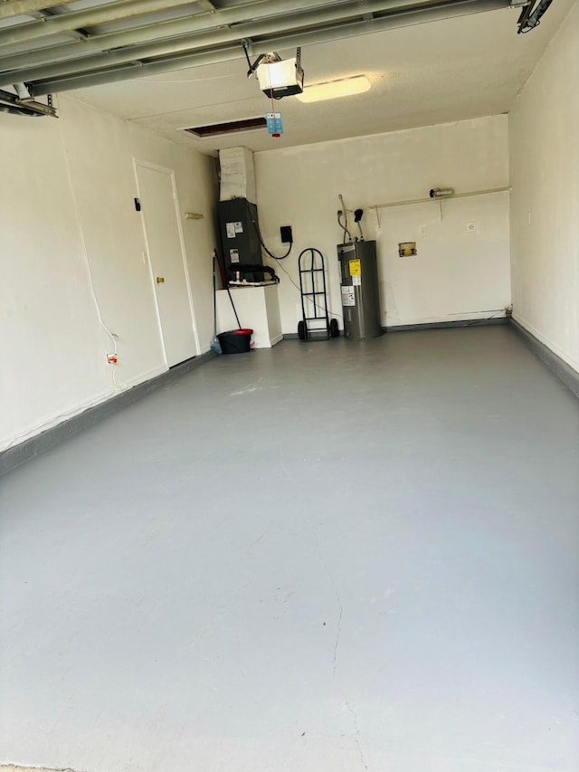 garage featuring electric water heater and a garage door opener