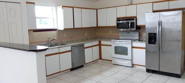 kitchen with white cabinets, appliances with stainless steel finishes, and sink