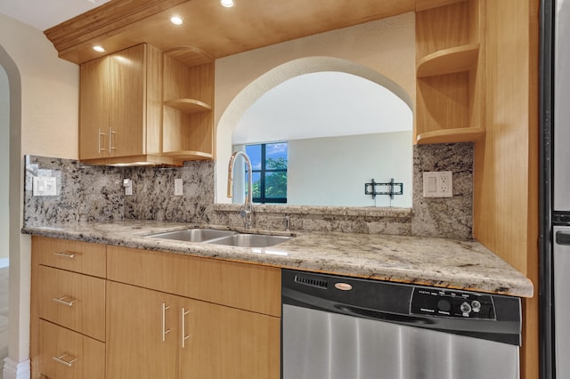 kitchen with sink, light stone counters, stainless steel dishwasher, decorative backsplash, and light brown cabinetry