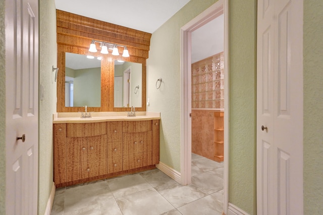 bathroom with wood walls, tile patterned flooring, and vanity