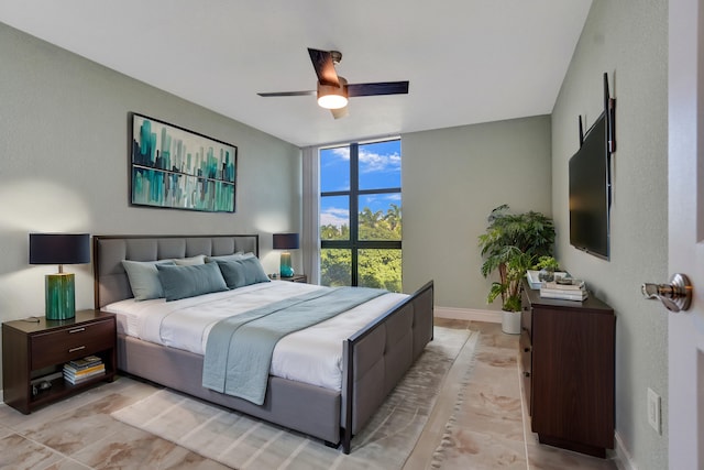 bedroom featuring ceiling fan and floor to ceiling windows