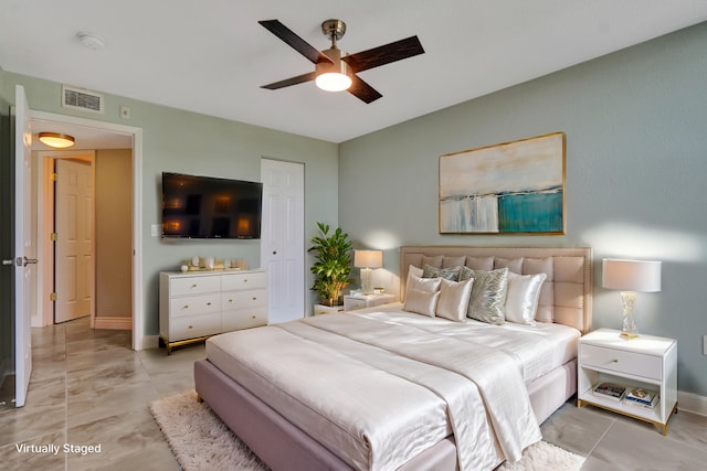 tiled bedroom featuring ceiling fan