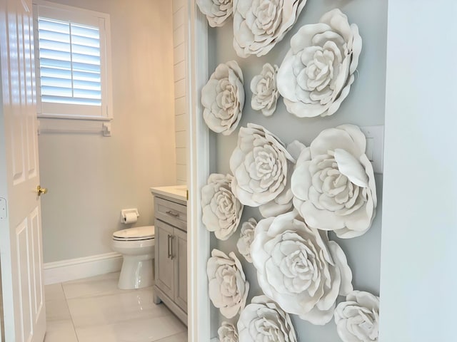 bathroom featuring toilet, vanity, and tile patterned floors