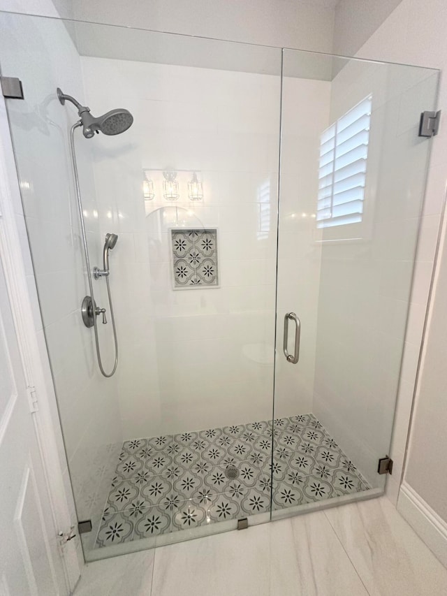 bathroom featuring tile patterned flooring and an enclosed shower