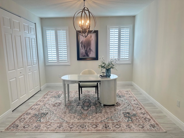 office area with a chandelier and light hardwood / wood-style floors