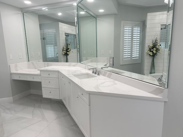 bathroom featuring vanity and a shower with door