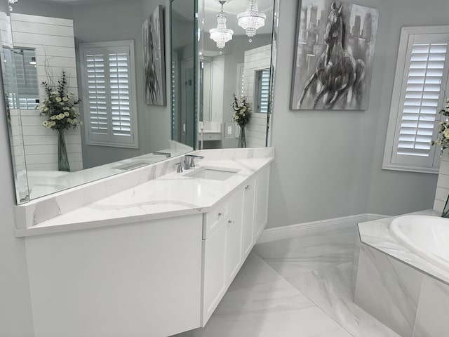 2727 Eleanor Way, Wellington, FL 33414 - bathroom with marble look tiles, vanity, a bath, and a chandelier