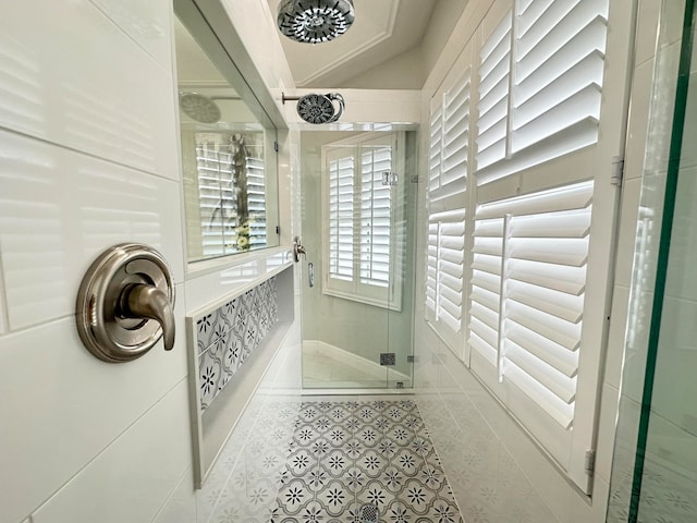 bathroom featuring a shower with shower door and tile patterned flooring