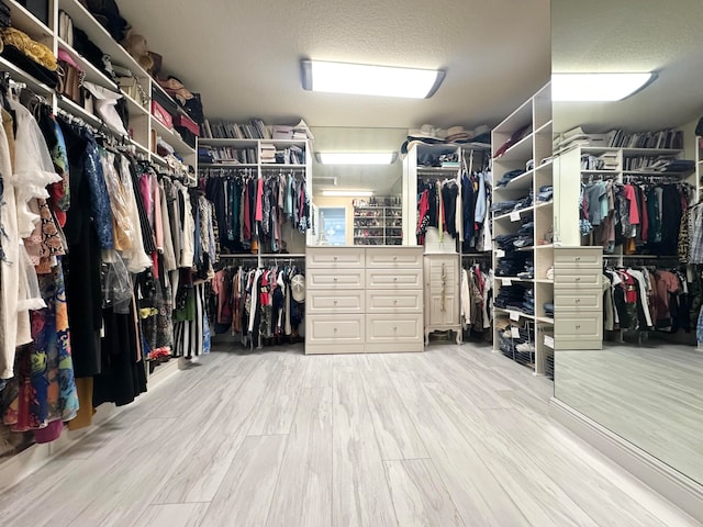 walk in closet featuring light hardwood / wood-style flooring