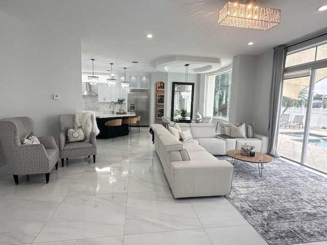 living room with a notable chandelier and a healthy amount of sunlight