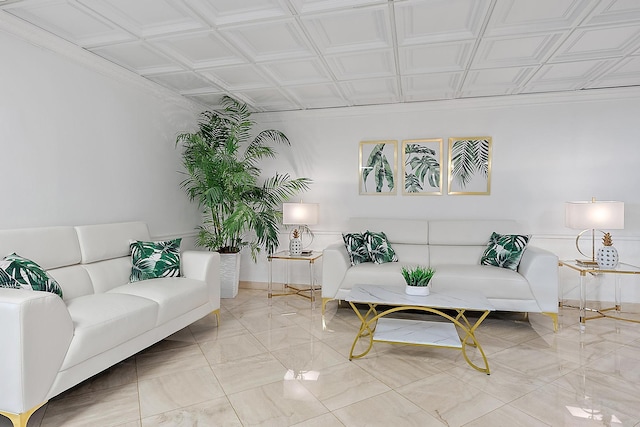 living area with an ornate ceiling and baseboards