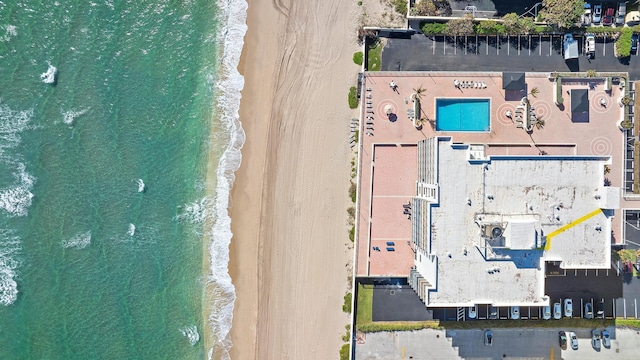 birds eye view of property with a view of the beach and a water view