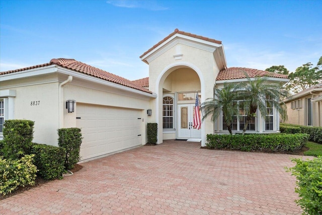 mediterranean / spanish house with a garage