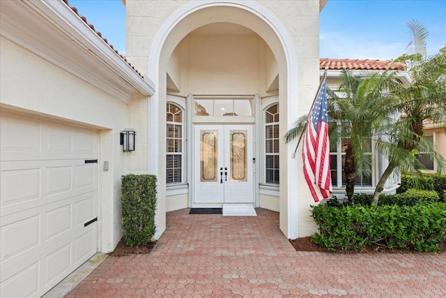 property entrance featuring french doors and a garage