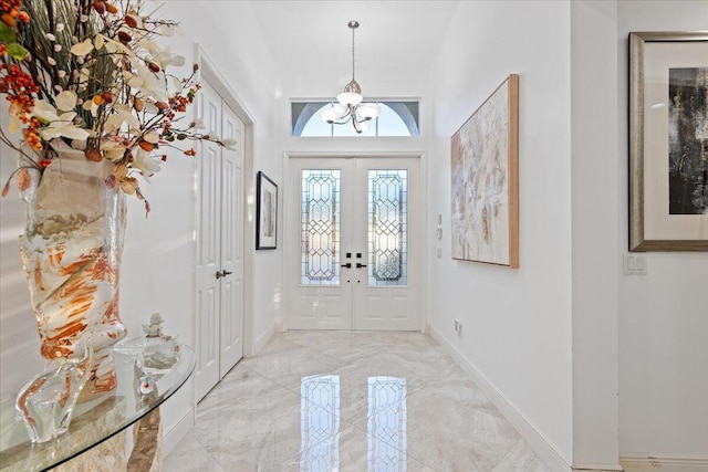 foyer with a chandelier and french doors