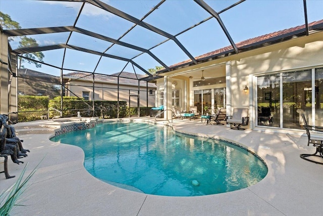 view of pool with a lanai, ceiling fan, and a patio area