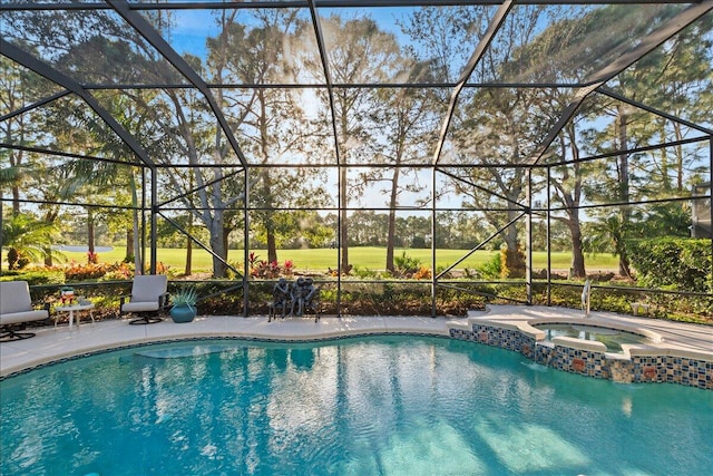 view of swimming pool featuring a patio area, a lanai, and an in ground hot tub