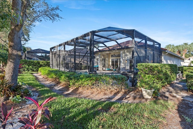 rear view of house featuring a lanai