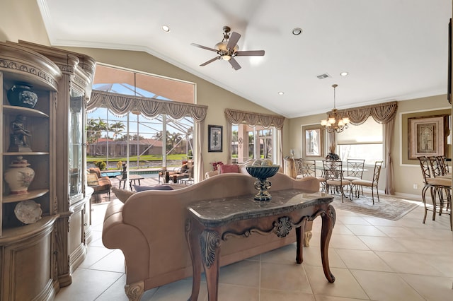 tiled living room featuring ceiling fan with notable chandelier, a healthy amount of sunlight, ornamental molding, and vaulted ceiling