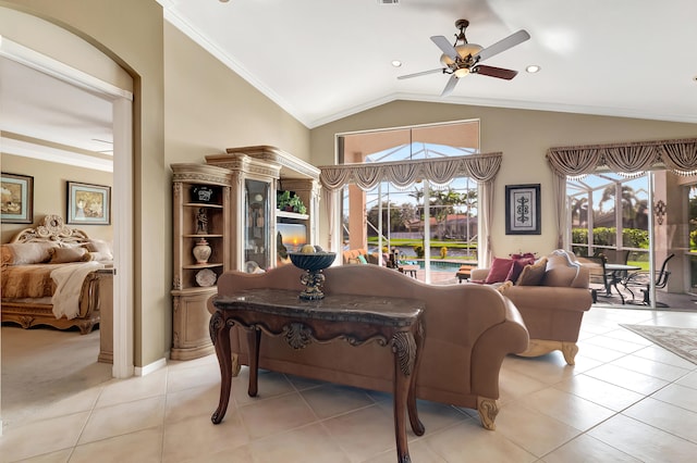 tiled living room with ceiling fan, vaulted ceiling, and ornamental molding