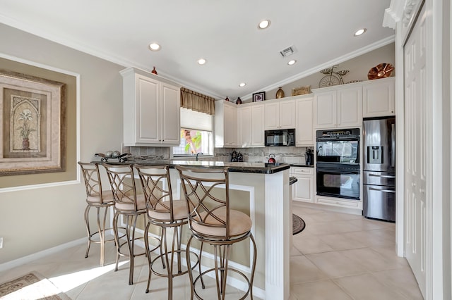 kitchen featuring tasteful backsplash, crown molding, black appliances, white cabinetry, and lofted ceiling