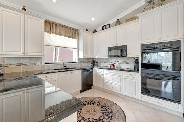 kitchen with black appliances, sink, vaulted ceiling, decorative backsplash, and white cabinetry