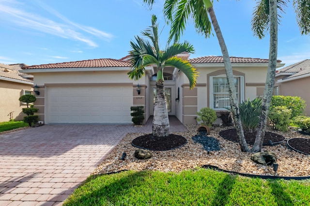 mediterranean / spanish-style home with a garage