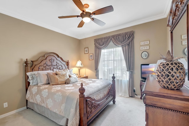 carpeted bedroom featuring ceiling fan and ornamental molding